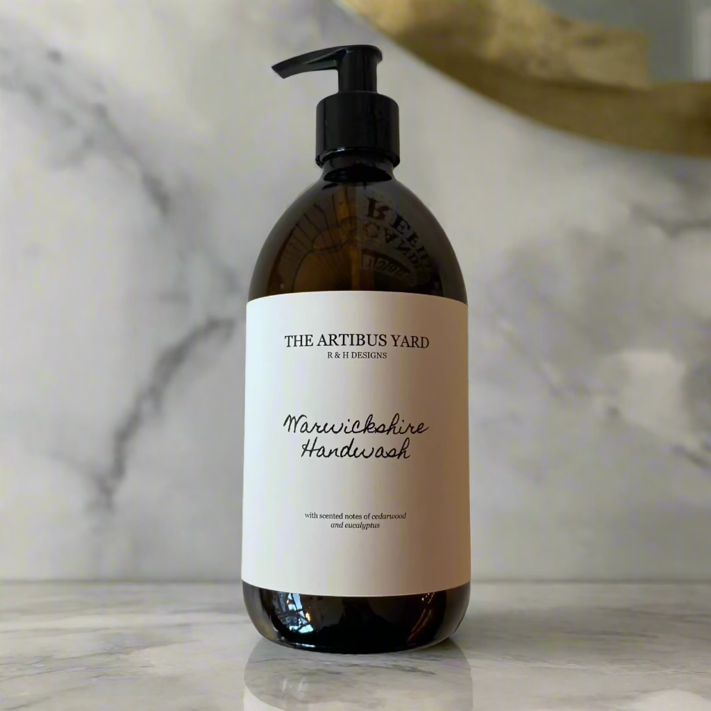 Warwickshire scented handwash by The Artibus Yard, crafted with gentle ingredients and woody and fresh notes, in an amber glass bottle with pump dispenser.