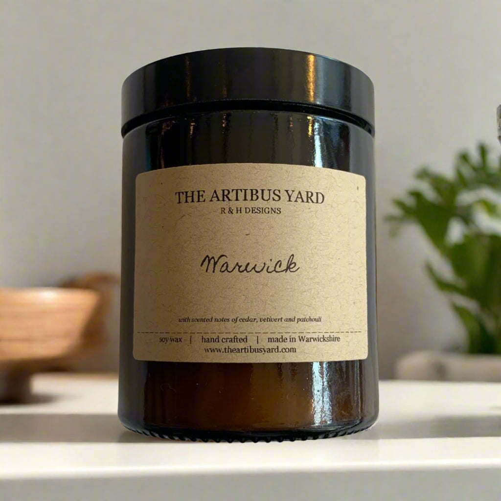 Hand-poured Warwick soy wax candle by The Artibus Yard, featuring notes of cedar, vetiver and patchouli; crafted in small batches in Warwickshire and poured into a reusable amber glass jar.