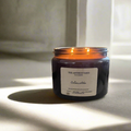 Hand-poured Cotswolds soy wax candle by The Artibus Yard, featuring notes of lavender, dark wood and vetiver; crafted in small batches in Warwickshire and poured into a reusable amber glass jar.