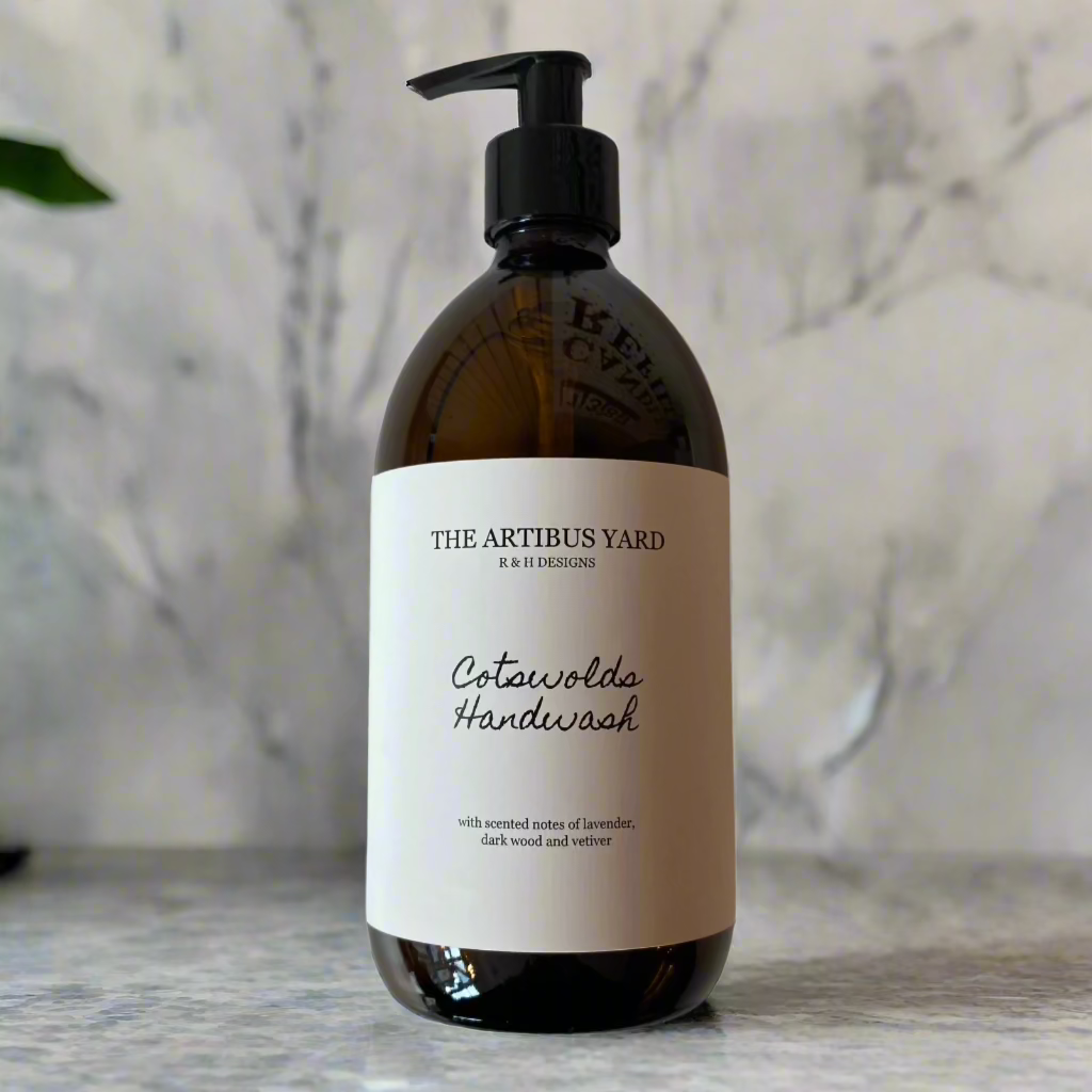 Cotswolds scented handwash by The Artibus Yard, crafted with gentle ingredients and warm and woody notes, in an amber glass bottle with pump dispenser.