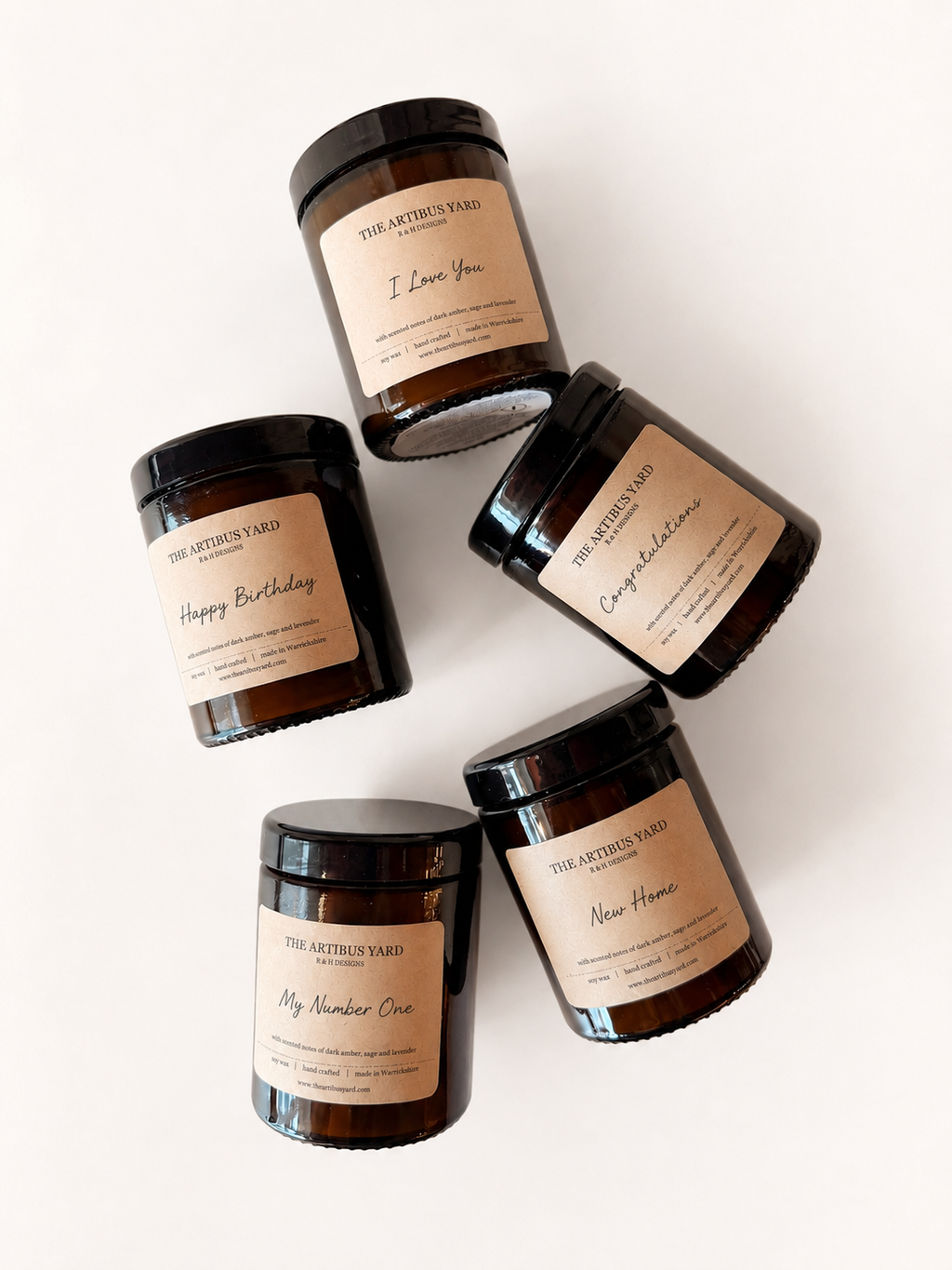Five candles with personalised labels on a white background
