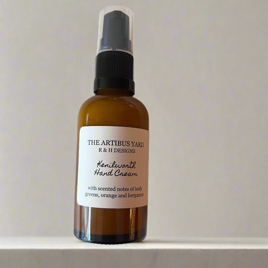 Kenilworth scented hand cream by The Artibus Yard, enriched with nourishing ingredients and leafy and citrus notes, packaged in an elegant easy to travel with amber glass bottle with pump dispenser. 