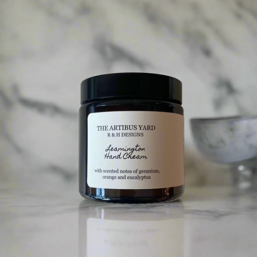 Leamington scented hand cream by The Artibus Yard, enriched with nourishing ingredients and fresh citrus and floral notes, packaged in an elegant amber glass jar.