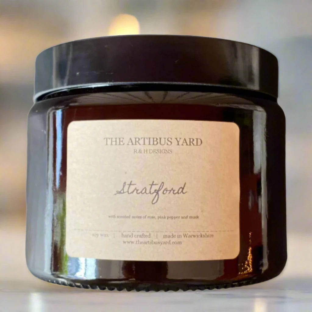 Hand-poured Stratford soy wax candle by The Artibus Yard, featuring notes of rose, pink pepper and musk; crafted in small batches in Warwickshire and poured into a reusable amber glass jar.