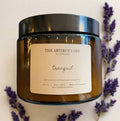 Hand-poured Tranquil soy wax candle by The Artibus Yard, featuring notes of lavender and peppermint; crafted in small batches in Warwickshire and poured into a reusable amber glass jar.