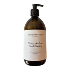 Warwickshire scented hand cream by The Artibus Yard, enriched with nourishing ingredients and fresh and woody notes, packaged in an amber glass bottle with pump dispenser. 