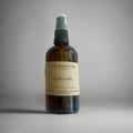 Cotswolds atmosphere mist by The Artibus Yard, featuring lavender, dark wood and vetiver notes in a sleek spray bottle.